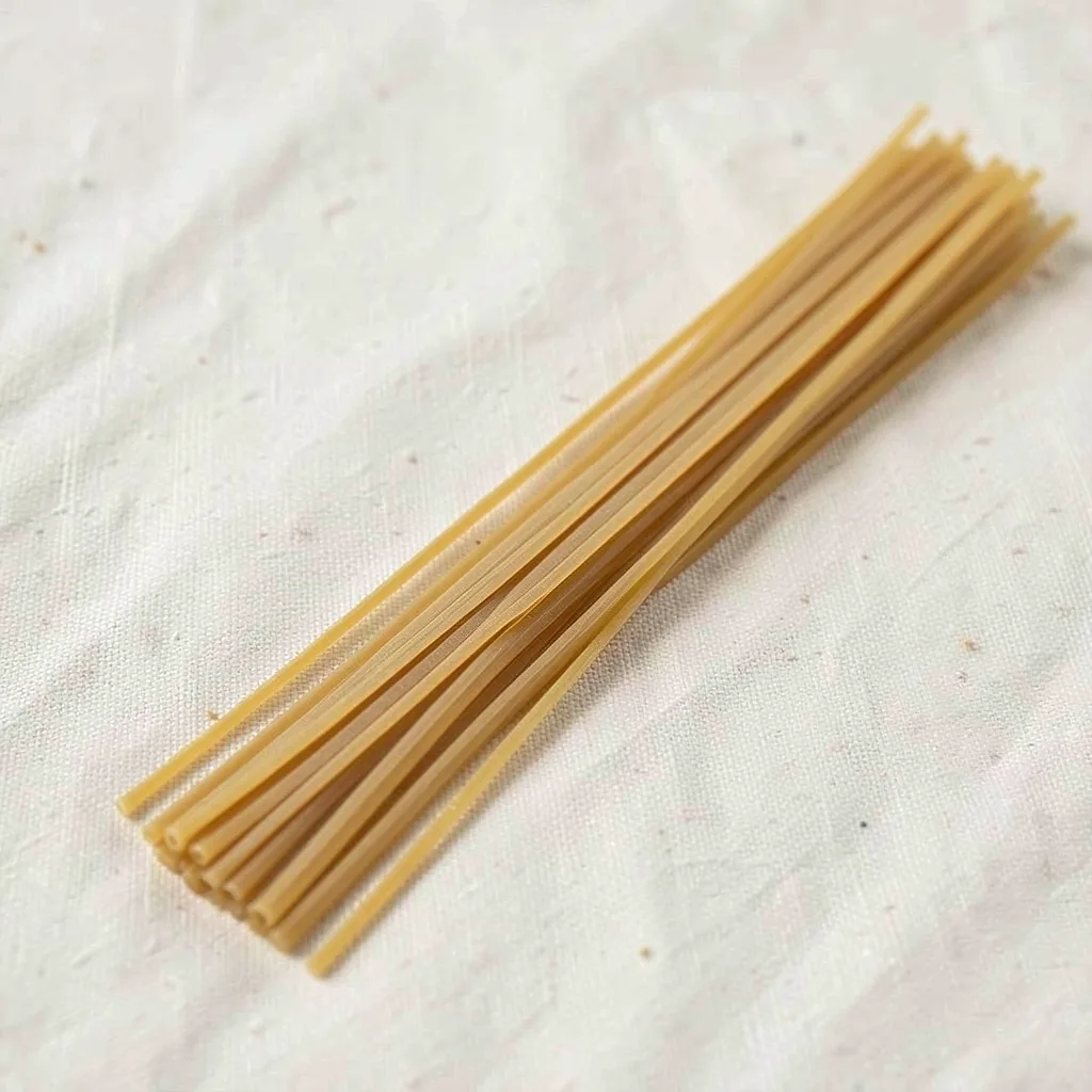 Capellini, uncooked, on linen