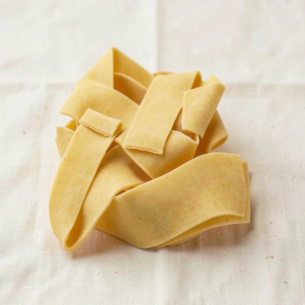 Pappardelle, uncooked, on linen